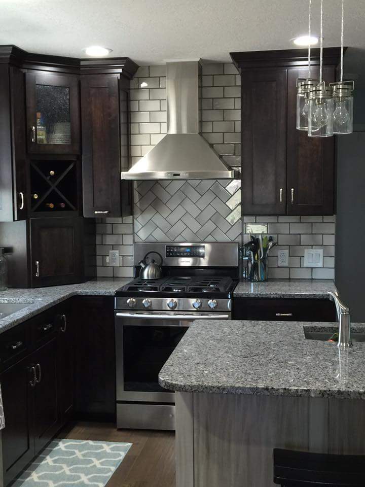 gray tile kitchen back splash with gray and black granite countertop