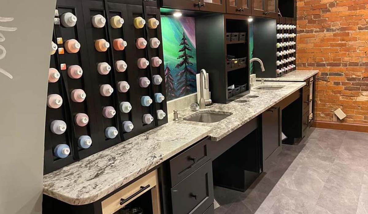 marble countertop, black cabinets, wine shelves